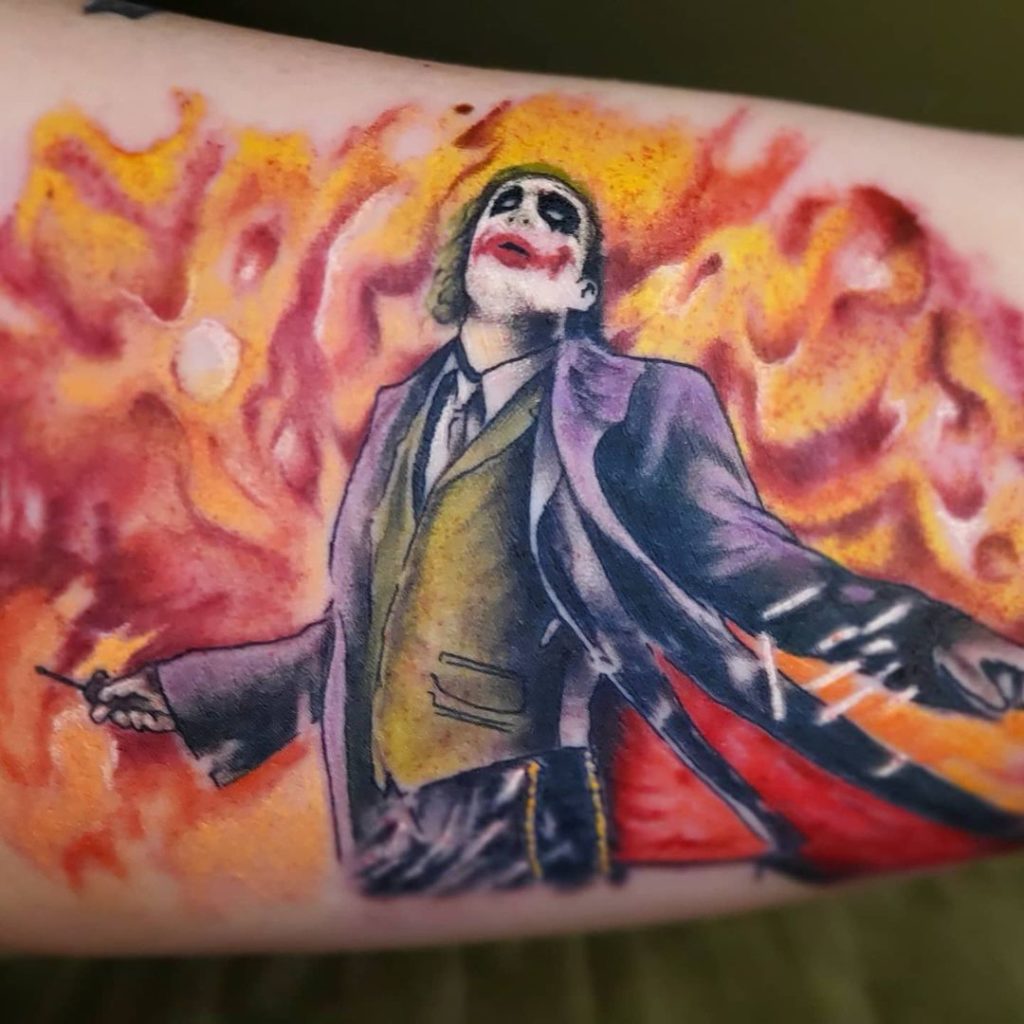 A tattoo of a joker holding a bat